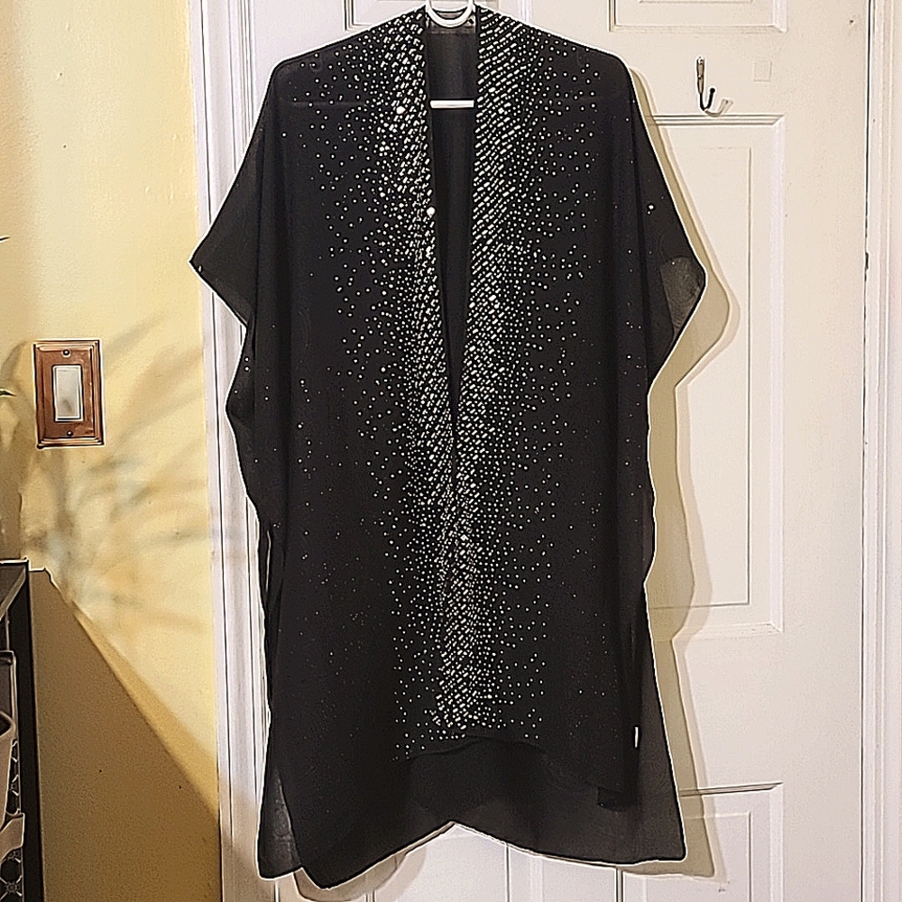 A black cover up use to give life to black dress for a night out.